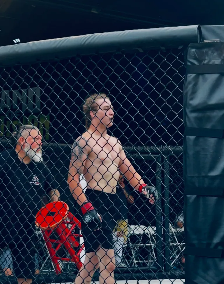 Nathan Johnson in the cage at his debut, LFS Middletown Mayhem, seen through the fence