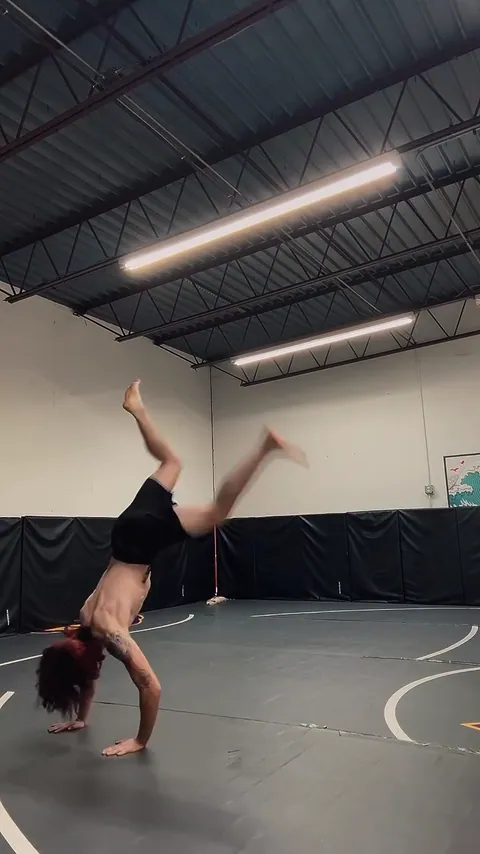 Nathan Johnson alone on the mats trying a flip. His caption: Day 1 of trying to learn this thingy